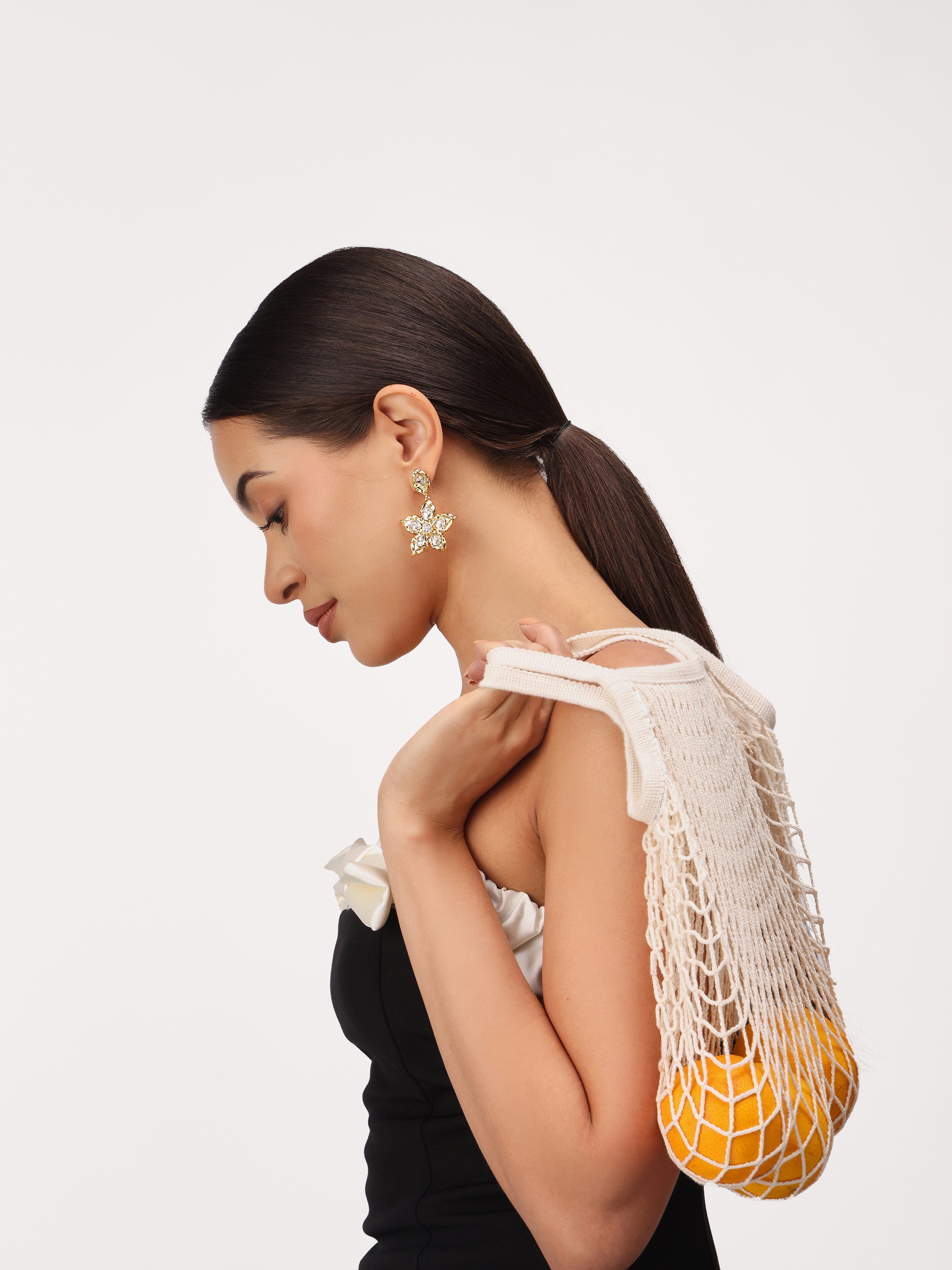 Model wearing real gold plated flower shaped crystal stone drop earrings