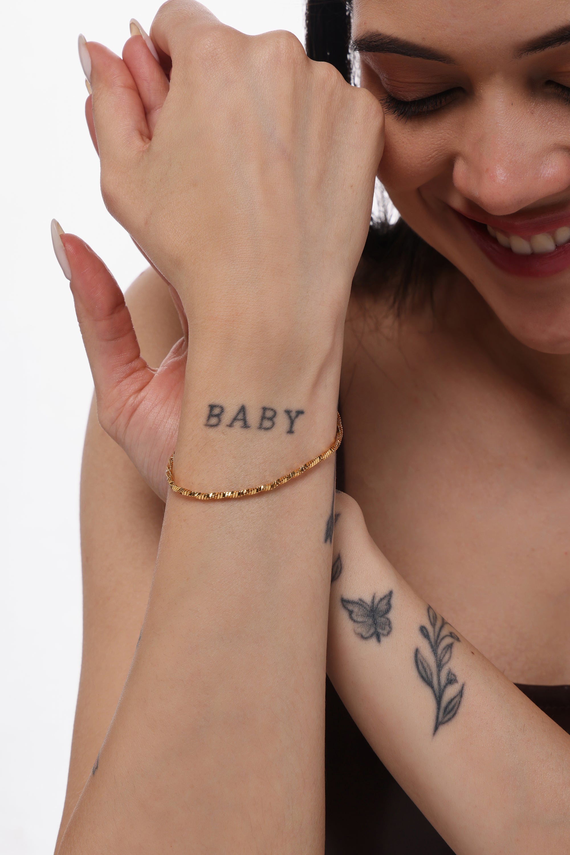 Twist Snake Bracelet — model shot, 14K gold-plated recycled brass bracelet by Sucra