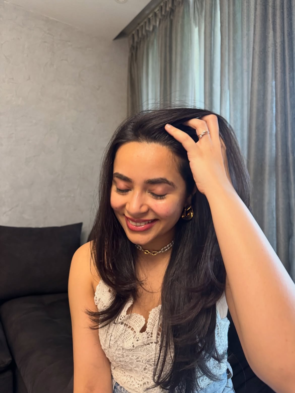 Anubha wearing the Anubha Twist earrings — candid lifestyle photo. Sucra Luxe.