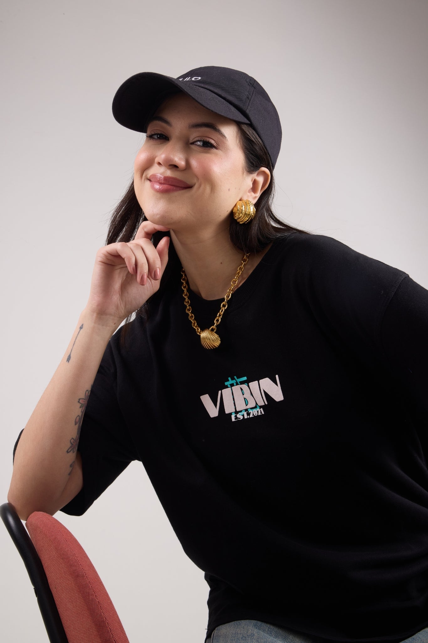Woman wearing gold shell studs and the shell chain from Sucra shell collection