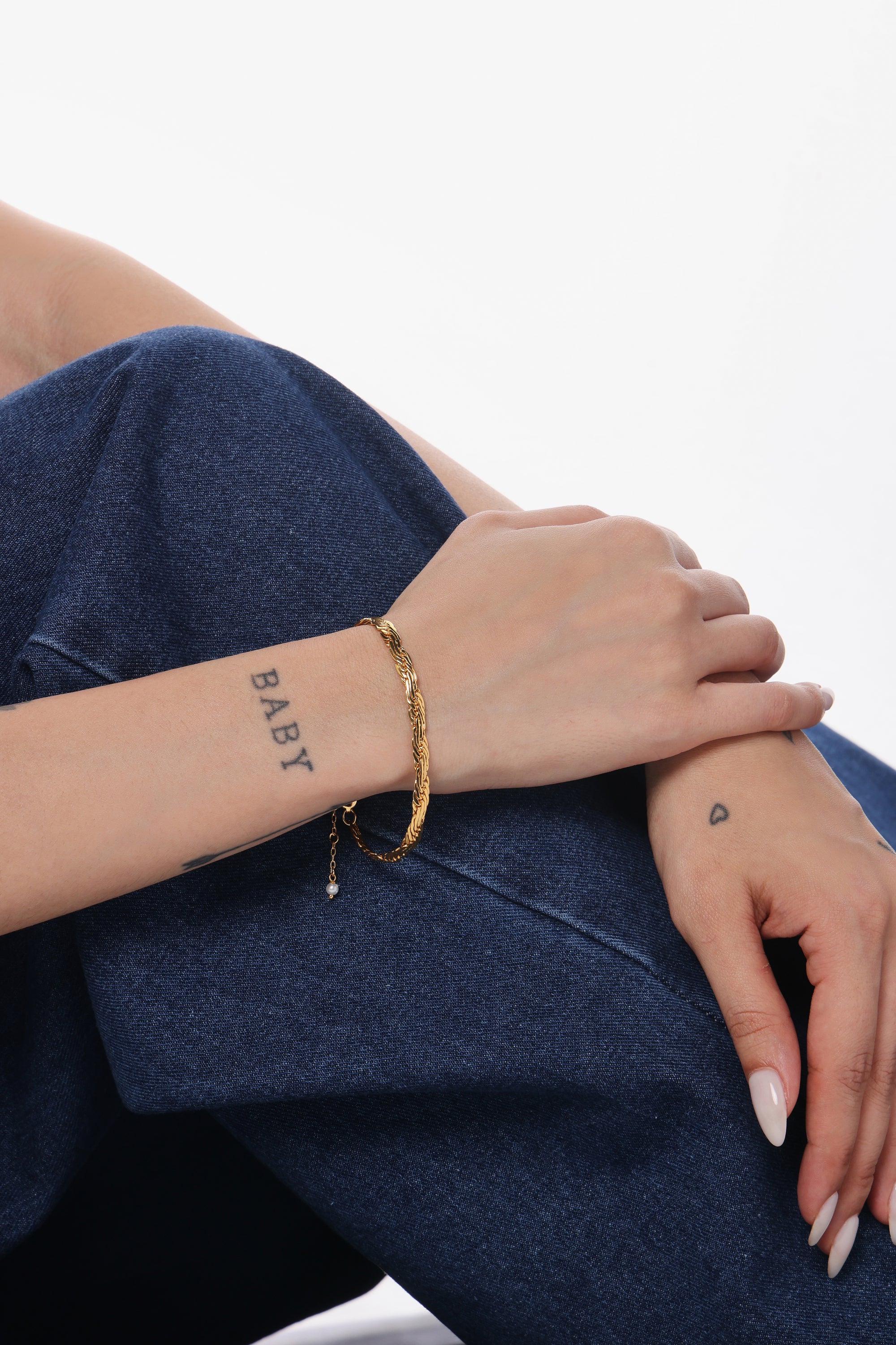 Rope Twist Bracelet — model shot, 14K gold-plated recycled brass bracelet by Sucra
